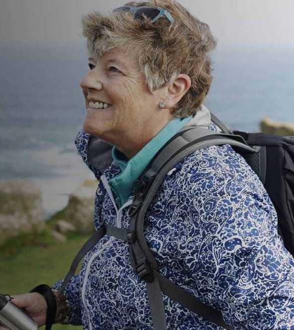 Lady backpacking on coastal cliff