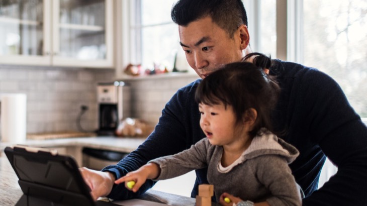 Father and daughter looking at laptop
