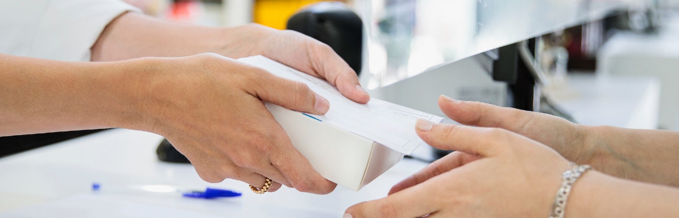Handing over a purchase at a shop counter