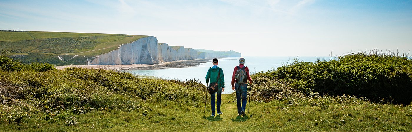 Two walkers on a coastal path