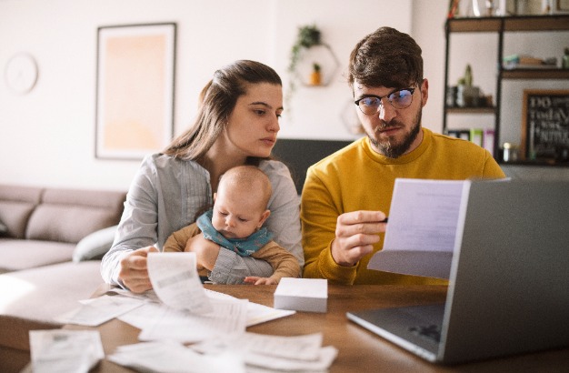 Image of young family looking through paper work